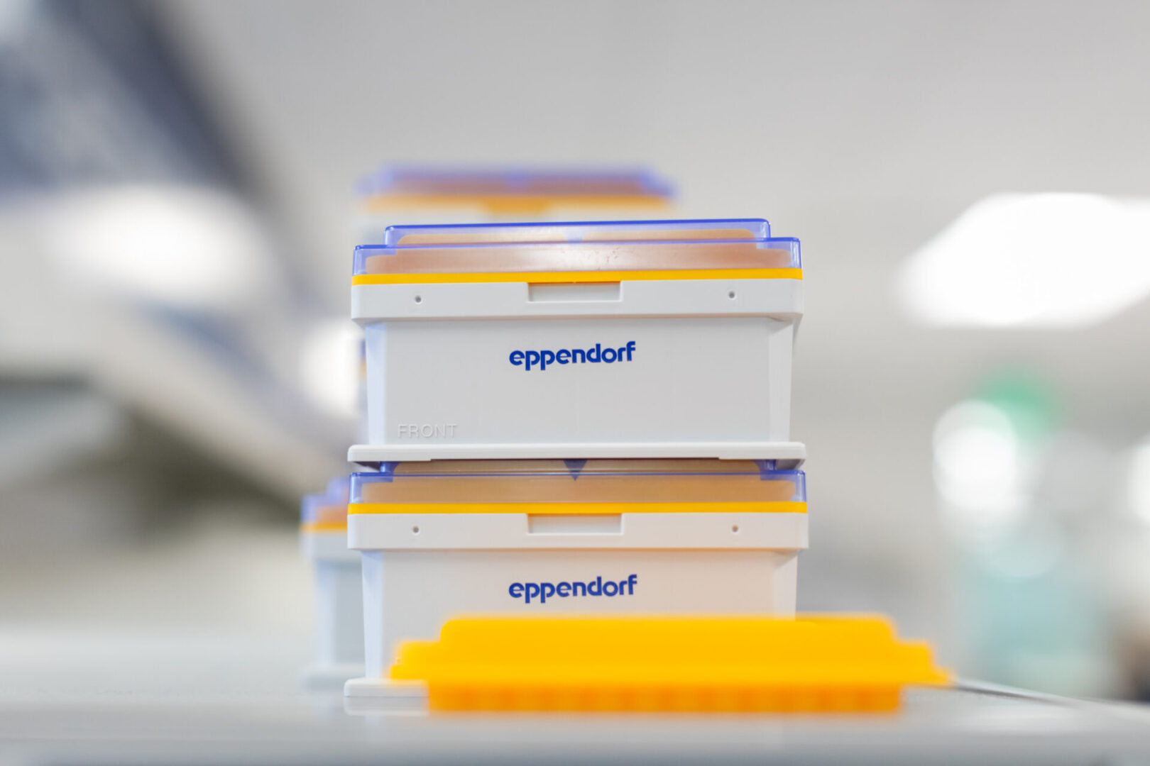 A stack of boxes with yellow lids on top.